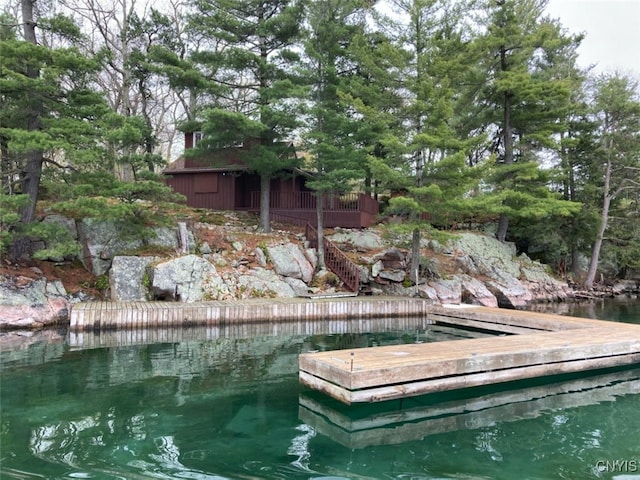 view of pool featuring a boat dock and a water view