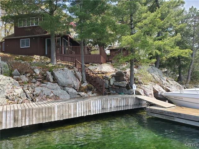 dock area featuring a deck with water view