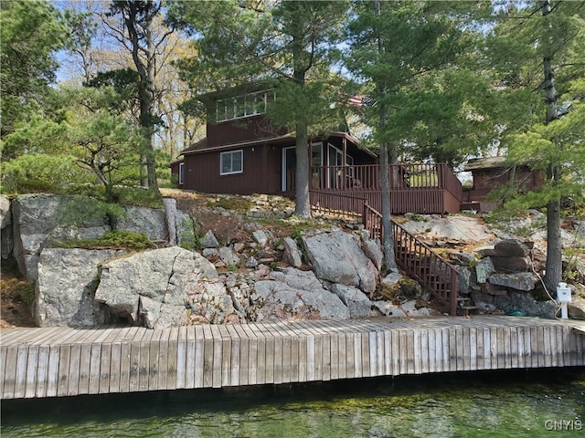 back of house with a deck with water view