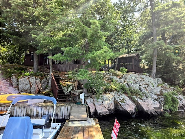 view of dock featuring a deck with water view