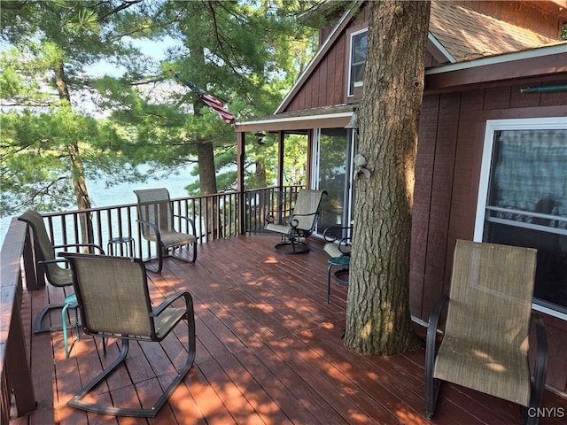 wooden deck featuring a water view