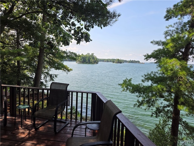 wooden deck featuring a water view