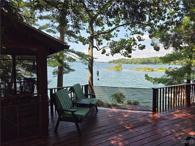 wooden deck featuring a water view