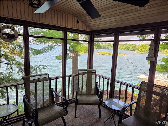 unfurnished sunroom featuring a water view, lofted ceiling, wooden ceiling, and plenty of natural light