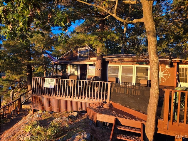 back of property featuring a wooden deck