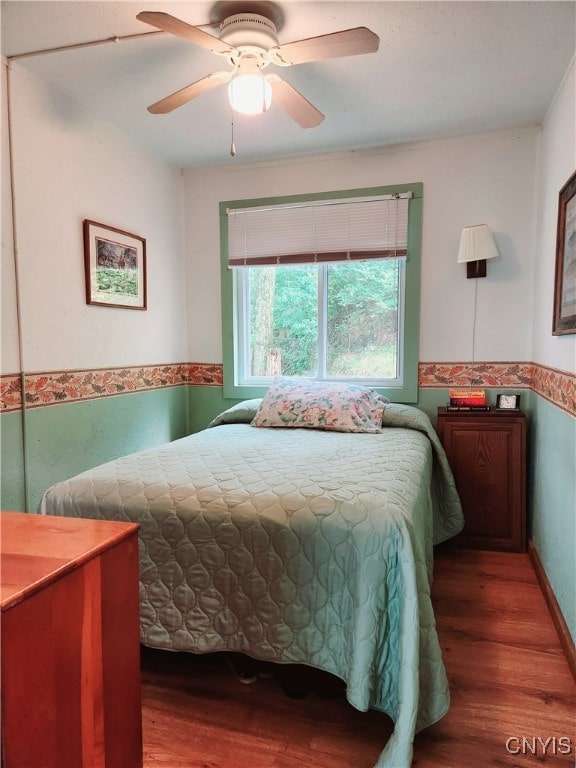 bedroom with ceiling fan and hardwood / wood-style floors