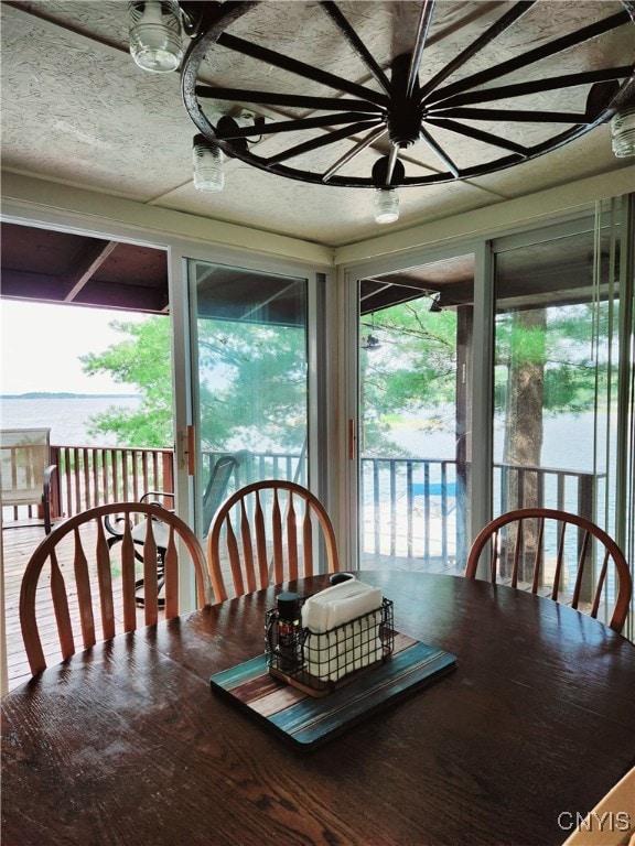 dining space with a textured ceiling and hardwood / wood-style floors