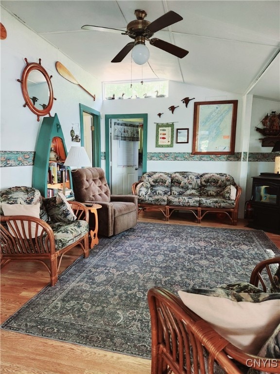 sitting room with ceiling fan, vaulted ceiling, and wood-type flooring