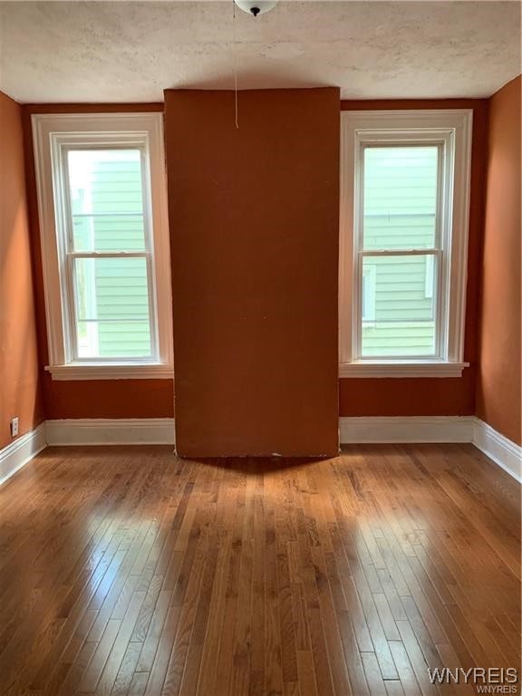 empty room featuring light hardwood / wood-style floors and a textured ceiling