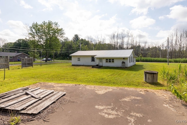 rear view of property with a lawn