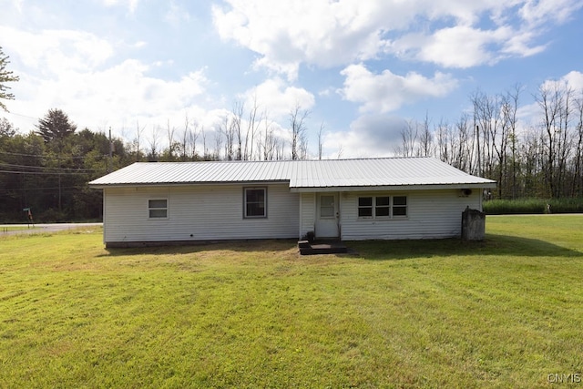 rear view of property with a yard