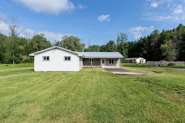 back of house featuring a lawn