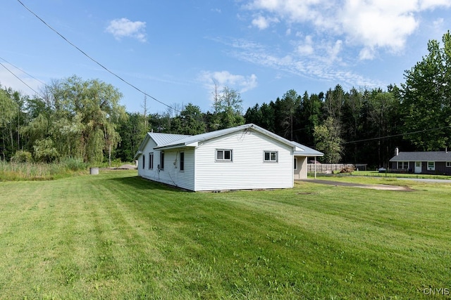 view of property exterior featuring a lawn