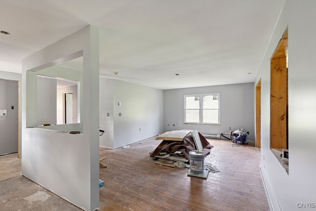 unfurnished room featuring a baseboard radiator and hardwood / wood-style floors