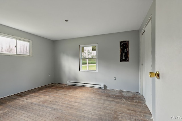 spare room with hardwood / wood-style flooring and baseboard heating