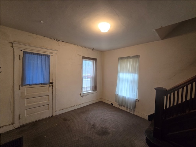 view of carpeted foyer entrance