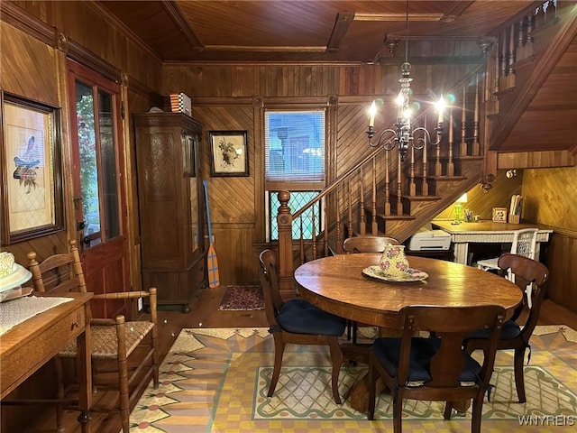 42916 St Lawrence Ave, Orleans, NY 13692 - dining area with wooden walls, stairway, wood ceiling, a chandelier, and wood finished floors