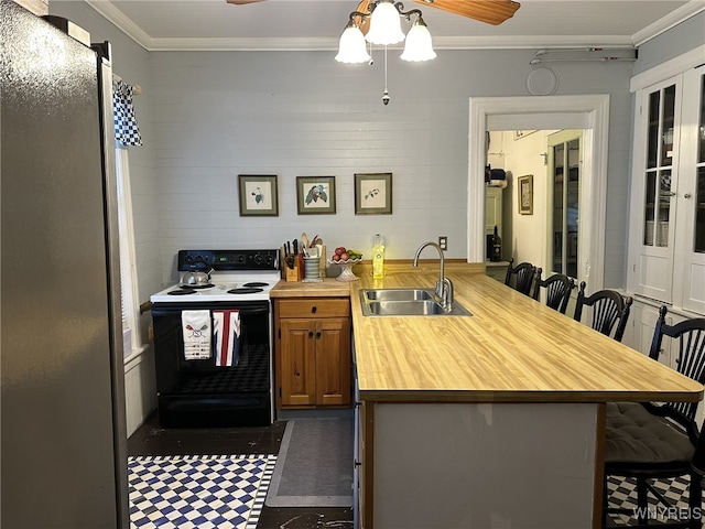 kitchen featuring ornamental molding, white electric range oven, sink, and a kitchen bar