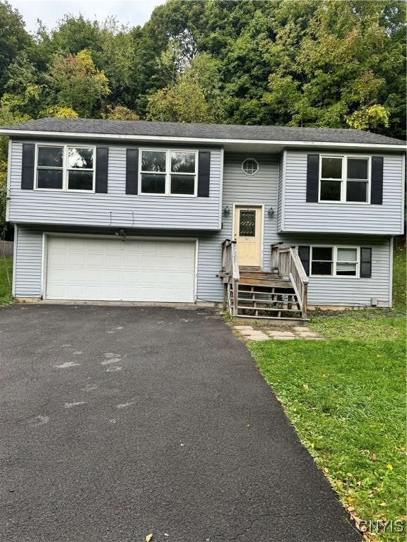 bi-level home featuring a front yard and a garage