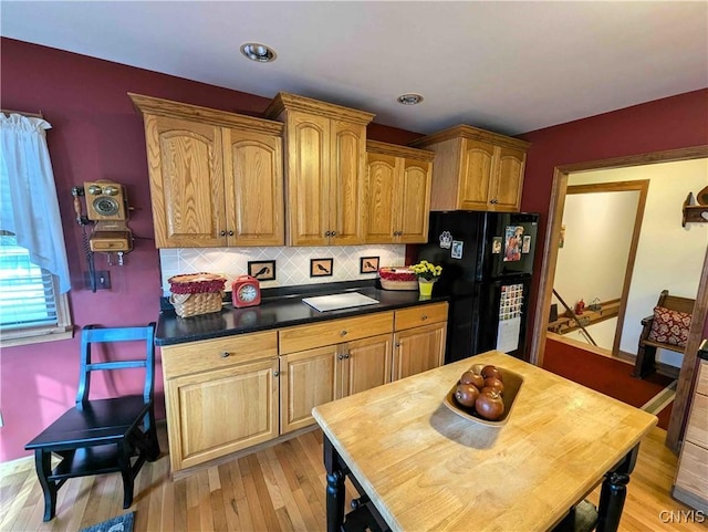 644 Main St, Independence, NY 14897 - kitchen featuring freestanding refrigerator, tasteful backsplash, dark countertops, light wood finished floors, and brown cabinets