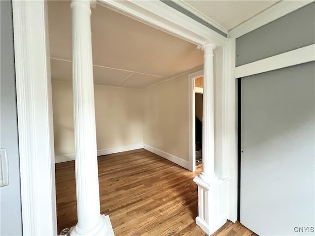 interior space with hardwood / wood-style flooring and decorative columns