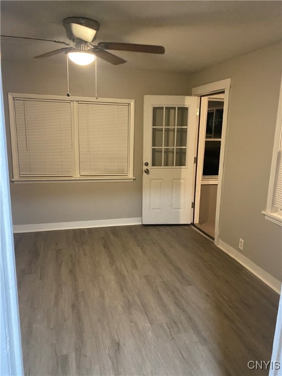 unfurnished room featuring dark hardwood / wood-style floors and ceiling fan