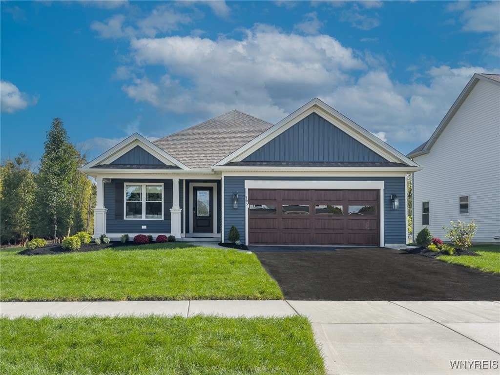 view of front of property with a front lawn and a garage