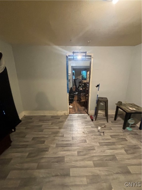 hallway with hardwood / wood-style flooring