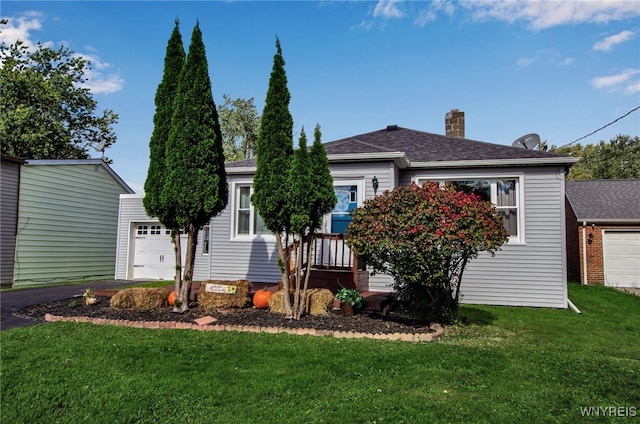 view of front of home with a garage and a front yard