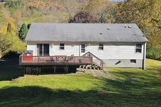 back of property featuring a yard and a wooden deck