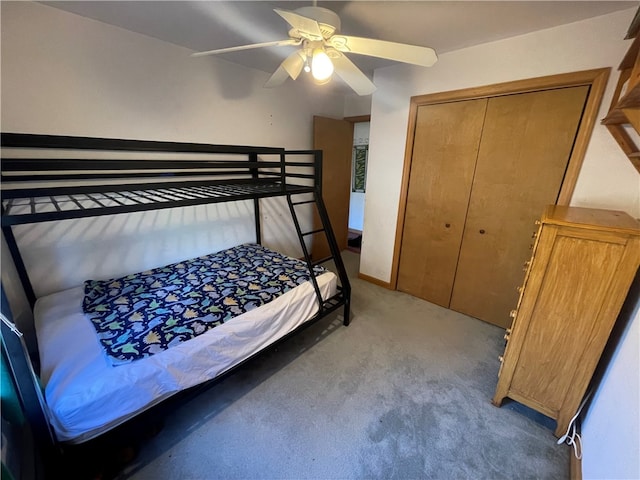 carpeted bedroom featuring a closet and ceiling fan