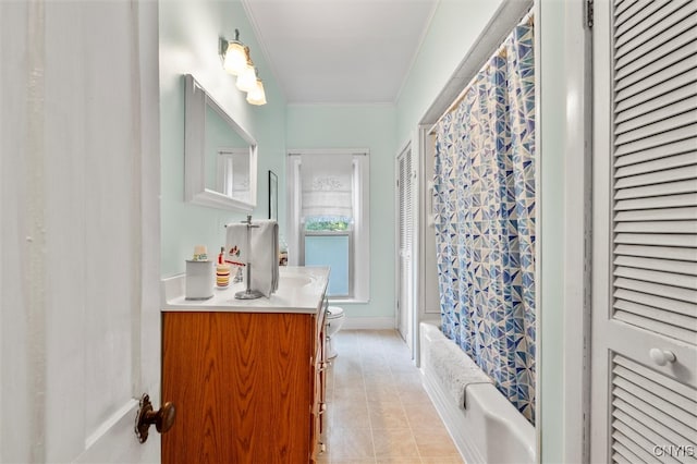 full bathroom featuring toilet, tile patterned floors, shower / tub combo with curtain, ornamental molding, and vanity