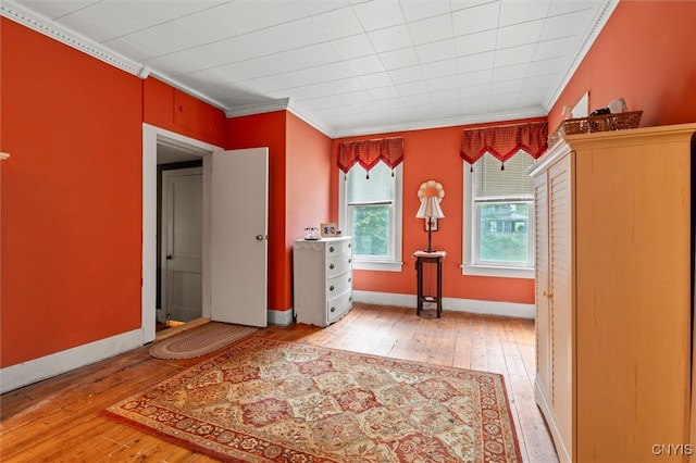 unfurnished bedroom with ornamental molding and light hardwood / wood-style flooring