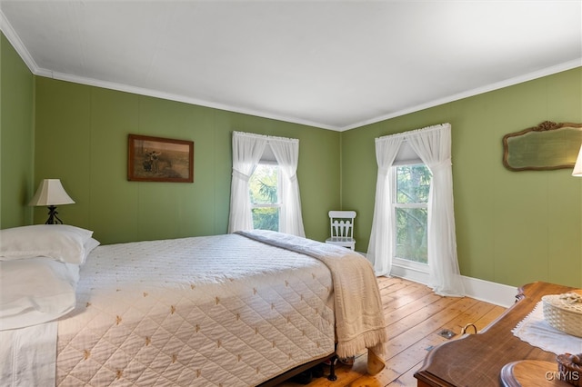 bedroom featuring wood-type flooring and crown molding