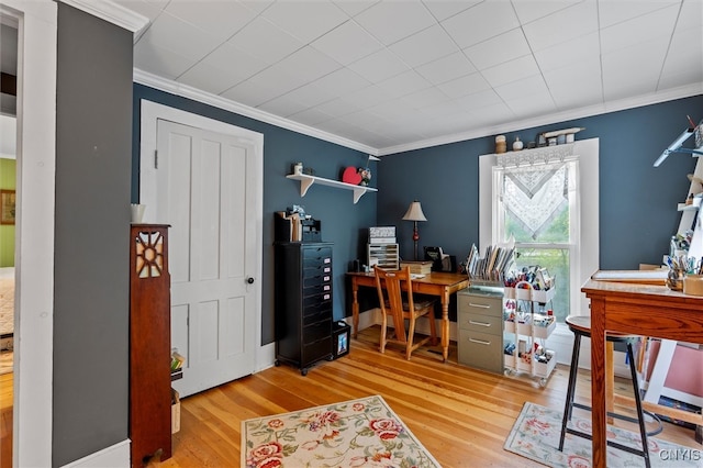 office area with light hardwood / wood-style flooring and ornamental molding