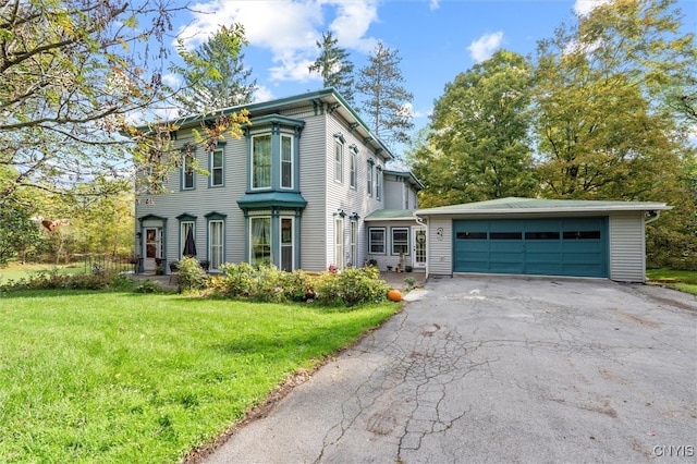 view of front of property featuring a front yard and a garage