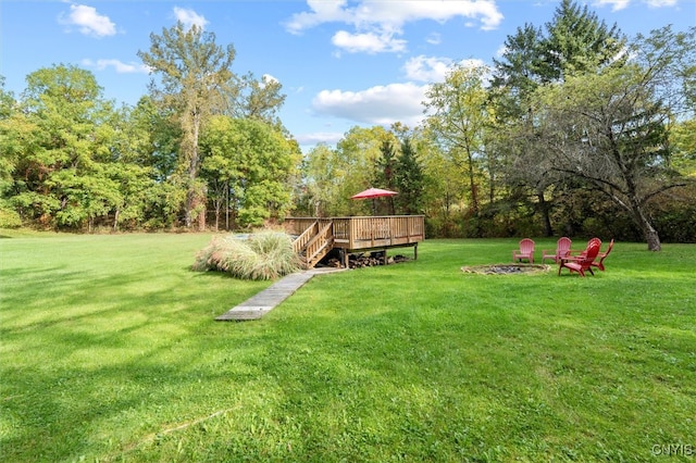 view of yard with an outdoor fire pit and a wooden deck