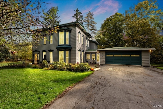 view of front facade with a garage and a yard