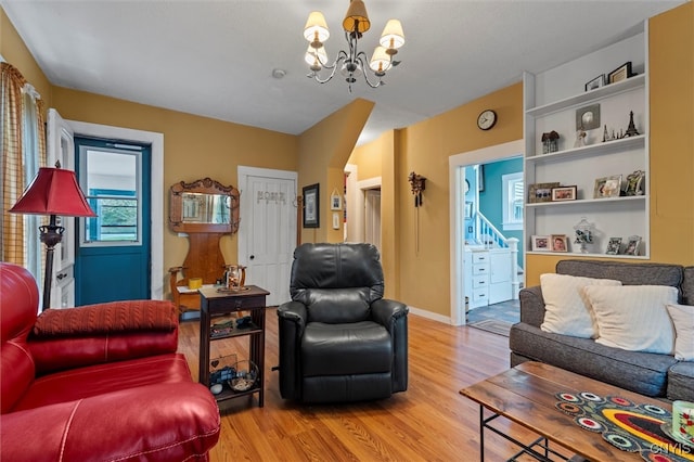 living room featuring an inviting chandelier and hardwood / wood-style floors