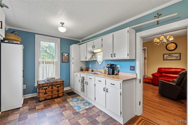 kitchen with white cabinets, white refrigerator, dark hardwood / wood-style floors, and ornamental molding