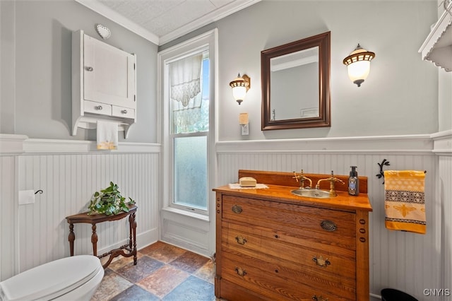 bathroom with ornamental molding, vanity, toilet, and washer / clothes dryer