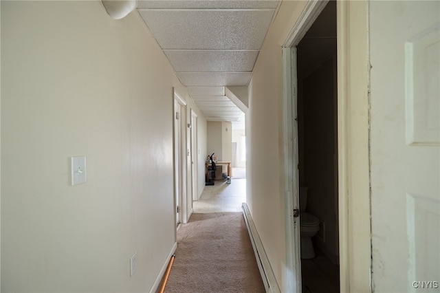 corridor featuring light carpet and a baseboard radiator