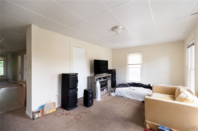 carpeted bedroom with a drop ceiling