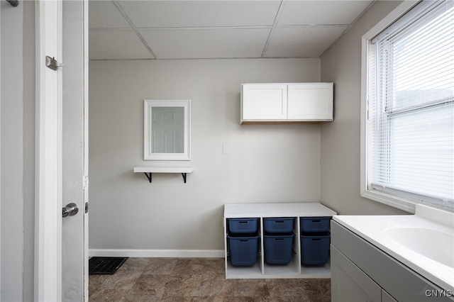 bathroom featuring vanity and a drop ceiling