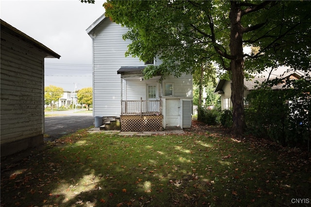 rear view of house featuring a yard