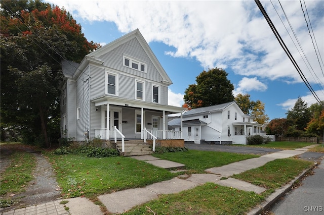 view of front facade with a front lawn and covered porch