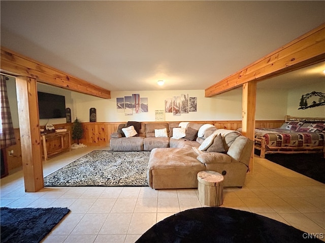 living room featuring wooden walls and light tile patterned floors