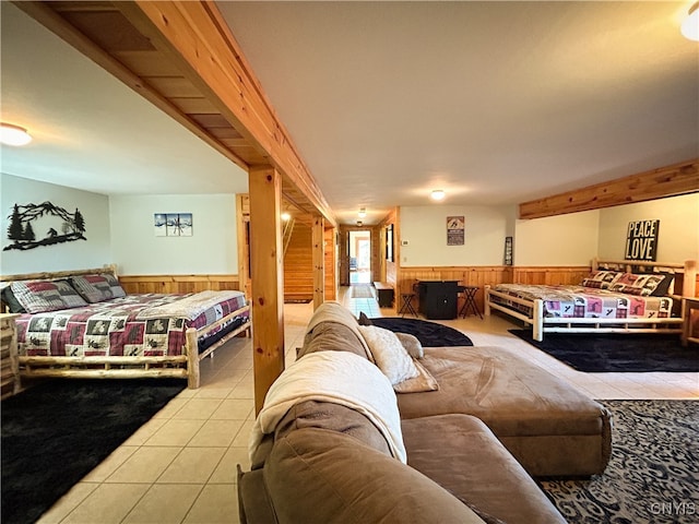 living room with wood walls and light tile patterned floors