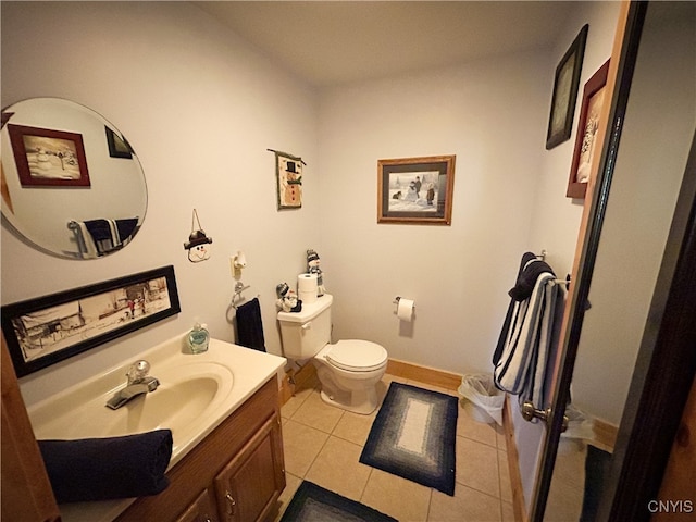 bathroom featuring toilet, vanity, and tile patterned floors