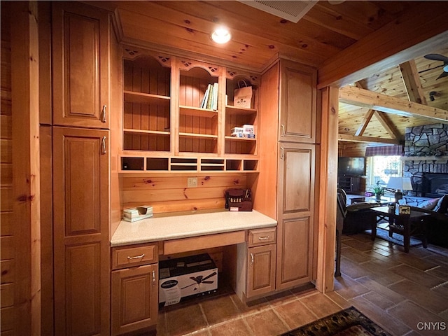 mudroom featuring lofted ceiling with beams, wood ceiling, and built in desk